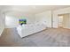 This bonus room offers a large white couch, neutral carpet, and lots of space at 104 Hemlock Cove Ct, Mooresville, NC 28117