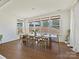 Bright dining area with modern table, chairs and a view of the outdoors through multiple windows at 104 Hemlock Cove Ct, Mooresville, NC 28117