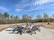 Outdoor fire pit area with seating and playground in the background offering a space to relax at 104 Hemlock Cove Ct, Mooresville, NC 28117