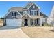 Charming two-story home featuring a stone-accented entryway and well-manicured lawn at 104 Hemlock Cove Ct, Mooresville, NC 28117