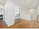 This well lit hallway features hardwood floors and gives access to the living room and the stairs at 104 Hemlock Cove Ct, Mooresville, NC 28117