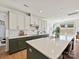 Bright, spacious kitchen with white cabinets, modern appliances, and an island that offers plenty of counter space at 104 Hemlock Cove Ct, Mooresville, NC 28117