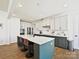 Modern kitchen with a large island, stylish bar stools, and ample cabinet space for cooking enjoyment at 104 Hemlock Cove Ct, Mooresville, NC 28117