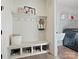 A well-organized mudroom featuring a built-in bench, storage, hooks, and a peek into the nearby laundry room at 104 Hemlock Cove Ct, Mooresville, NC 28117