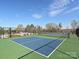 Well-maintained tennis court with a blue surface, perfect for recreational games and fitness at 104 Hemlock Cove Ct, Mooresville, NC 28117