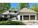Back exterior features a three-car garage, a patio area and a lush lawn at 105 Beach Ln, Mooresville, NC 28117