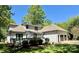 Spacious back exterior with deck area, manicured lawn, and a three-car garage at 105 Beach Ln, Mooresville, NC 28117