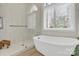 Well-lit bathroom showcasing a glass-enclosed shower, soaking tub, and large window at 105 Beach Ln, Mooresville, NC 28117