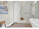 Bright bathroom showcasing a glass-enclosed shower, soaking tub, and modern fixtures at 105 Beach Ln, Mooresville, NC 28117