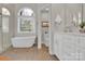 Bathroom features a soaking tub, separate shower, and a vanity with modern fixtures at 105 Beach Ln, Mooresville, NC 28117