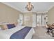 Inviting bedroom features a decorative chandelier, neutral walls, and a comfortable bed at 105 Beach Ln, Mooresville, NC 28117