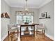 Bright dining area with a modern chandelier, hardwood floors, and comfortable seating at 105 Beach Ln, Mooresville, NC 28117
