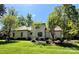 View of the well-maintained back exterior with manicured lawn and mature trees at 105 Beach Ln, Mooresville, NC 28117