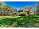 Exterior view of a home with spacious green backyard surrounded by mature trees at 107 Bare Foot Ln, Mooresville, NC 28117