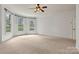 Bright bedroom with multiple windows offering natural light and neutral carpet at 107 Bare Foot Ln, Mooresville, NC 28117