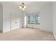 Bright bedroom with large windows, neutral carpet, and ample closet space at 107 Bare Foot Ln, Mooresville, NC 28117