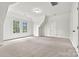 Bedroom featuring neutral carpet, two windows, and white trim at 107 Bare Foot Ln, Mooresville, NC 28117