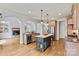 Open kitchen showcases a center island, stainless steel appliances, granite countertops, and hardwood floors at 107 Bare Foot Ln, Mooresville, NC 28117