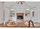 Cozy living room with a brick fireplace, built-in shelving, and hardwood floors, as seen from the granite countertop at 107 Bare Foot Ln, Mooresville, NC 28117