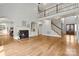 Spacious living room with high ceilings, hardwood floors, fireplace, and staircase at 107 Bare Foot Ln, Mooresville, NC 28117