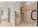Walk-in shower features tile surround, a glass door, a rainfall showerhead and a built-in bench at 107 Bare Foot Ln, Mooresville, NC 28117