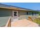 The back deck offers a quiet view of the home's exterior and surrounding lush greenery at 1127 Mckay Rd, Newton, NC 28658