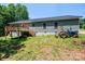 The rear exterior features a new deck with wooden stairs, perfect for outdoor entertaining and relaxation at 1127 Mckay Rd, Newton, NC 28658