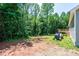 A spacious backyard presents a picturesque landscape, enhanced with a tractor and vibrant green trees at 1127 Mckay Rd, Newton, NC 28658