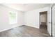 Cozy bedroom with neutral walls, wood-look flooring, and a bright window at 1127 Mckay Rd, Newton, NC 28658