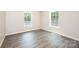 Bedroom with hardwood floors and two windows at 1127 Mckay Rd, Newton, NC 28658