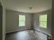 Bedroom with wood flooring and natural light from two windows at 1127 Mckay Rd, Newton, NC 28658