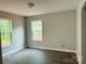Bedroom with wood flooring and natural light from two windows at 1127 Mckay Rd, Newton, NC 28658