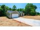 Single-story home with a two car garage and long driveway surrounded by trees, in the process of new construction at 1127 Mckay Rd, Newton, NC 28658
