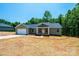 New construction, single-story home featuring a front porch and attached garage, set on a partially wooded lot at 1127 Mckay Rd, Newton, NC 28658