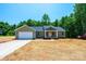 Single-story house with attached garage and front porch surrounded by trees, showing signs of new construction at 1127 Mckay Rd, Newton, NC 28658