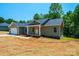 Charming single-story home with a covered front porch and an attached garage, nestled among mature trees at 1127 Mckay Rd, Newton, NC 28658