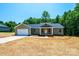 Single-story home with an attached garage, a welcoming front porch and large windows, in new neighborhood at 1127 Mckay Rd, Newton, NC 28658