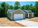 New construction single-story house with a two car garage in a rural, treed, suburban neighborhood at 1127 Mckay Rd, Newton, NC 28658