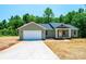 One-story house with attached two car garage and inviting front porch, perfect for suburban living at 1127 Mckay Rd, Newton, NC 28658