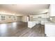 Open concept kitchen with white cabinets, center island, and wood-look floors at 1127 Mckay Rd, Newton, NC 28658