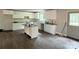 Bright kitchen with white cabinets, stainless sink, hardwood floors, and center island at 1127 Mckay Rd, Newton, NC 28658