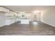 Modern kitchen with white cabinets, stone countertops, and laminate flooring, creating an inviting space at 1127 Mckay Rd, Newton, NC 28658