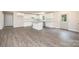 Bright, airy kitchen with white cabinets, center island, and wood-look floors at 1127 Mckay Rd, Newton, NC 28658