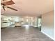 Open-concept living area featuring modern ceiling fan, wood floors, and access to kitchen and exterior at 1127 Mckay Rd, Newton, NC 28658