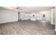 Open concept living room and kitchen space featuring laminate floors and ample natural light at 1127 Mckay Rd, Newton, NC 28658