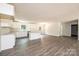 Open concept living room and kitchen featuring wood-look floors and neutral walls at 1127 Mckay Rd, Newton, NC 28658