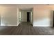 Open-concept living area with wood floors and neutral paint at 1127 Mckay Rd, Newton, NC 28658