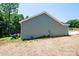 The side exterior of this ranch features a clean, durable vinyl siding and well-maintained yard space at 1127 Mckay Rd, Newton, NC 28658