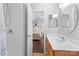 Bright bathroom showcasing a walk-in shower, wood vanity, and a peek into the bedroom at 11507 Rabbit Ridge Rd, Charlotte, NC 28270