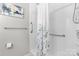Bathroom featuring a white tiled shower with glass door and safety bars at 11507 Rabbit Ridge Rd, Charlotte, NC 28270